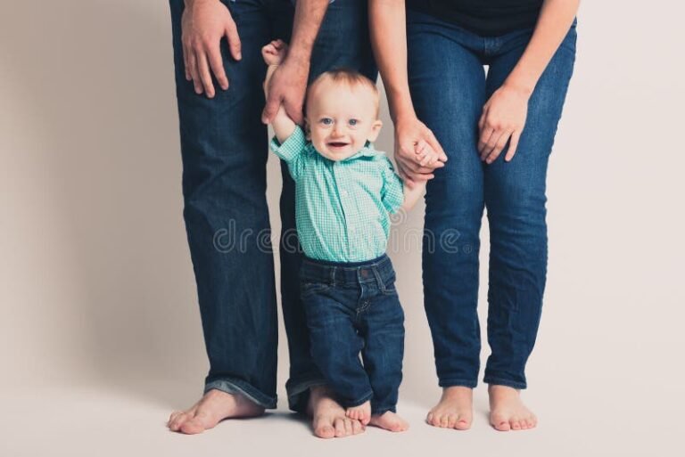 bebe con manos de padres sonrientes